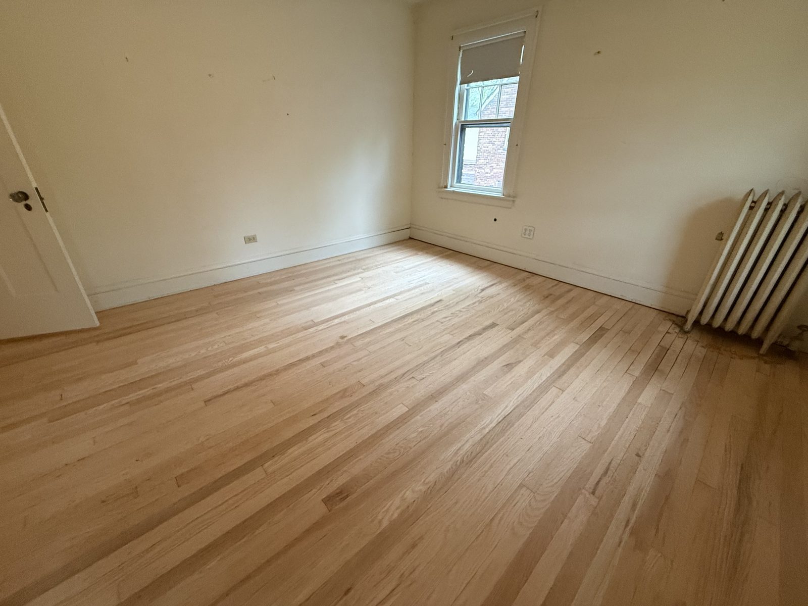 Refinished bedroom hardwood floor in a Lakewood home